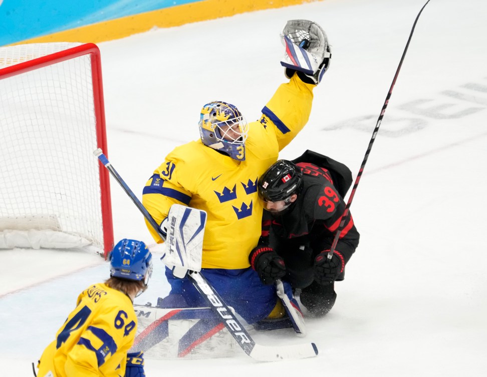 Team Sweden goalkeeper Lars Johansson (31) makes a save as Team Canada forward Landon Ferraro