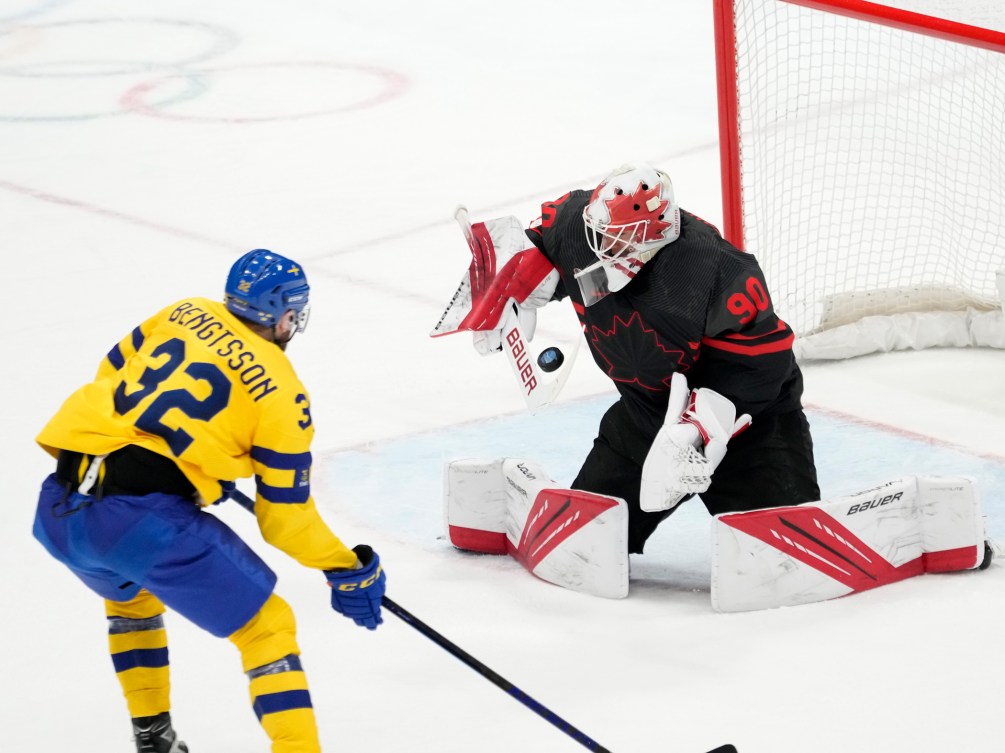 Team Canada goalkeeper Matt Tomkins (90) stops Team Sweden defender Lukas Bengtsson