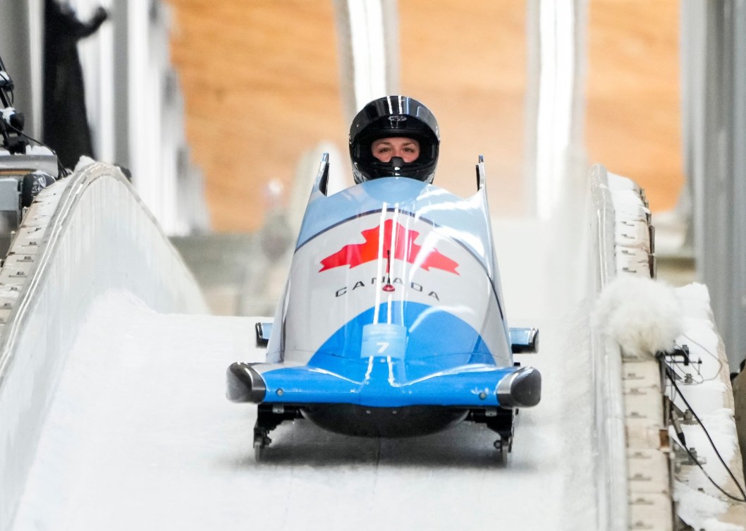 Front shot of Christine de Bruin driving bobsled into finish area