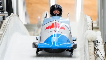 Front shot of Christine de Bruin driving bobsled into finish area