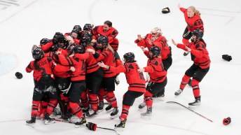 Team Canada's women's hockey team celebrates its gold medal win