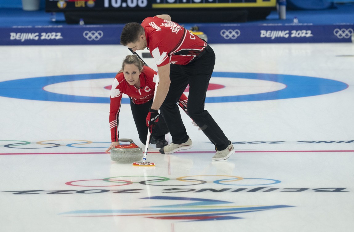 John Morris sweeps a stone thrown by Rachel Homan