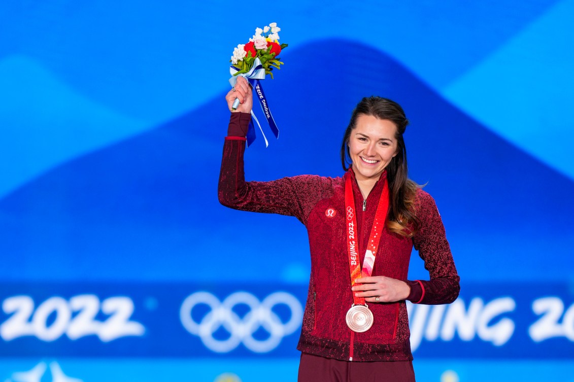 Isabelle Weidemann wears her bronze medal on the podium at Beijing 2022