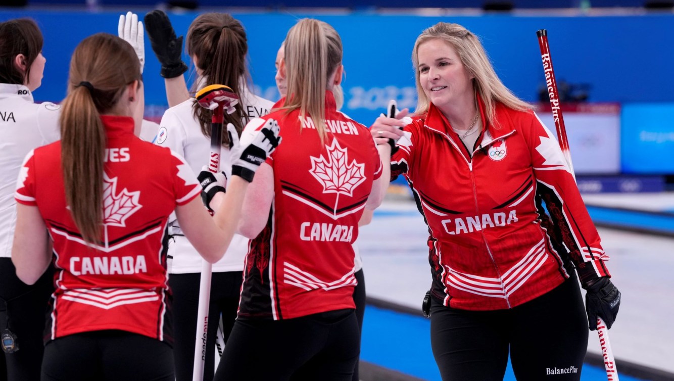 Jennifer Jones shakes hands with her teammates after a win