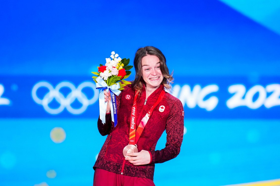 Kim Boutin smiles with her bronze medal on the podium at Beijing 2022
