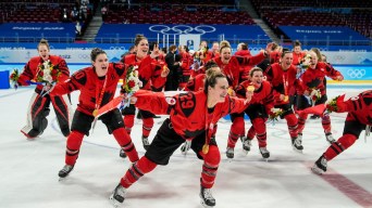 Marie-Philip Poulin and Team Canada celebrate winning women's hockey gold medal