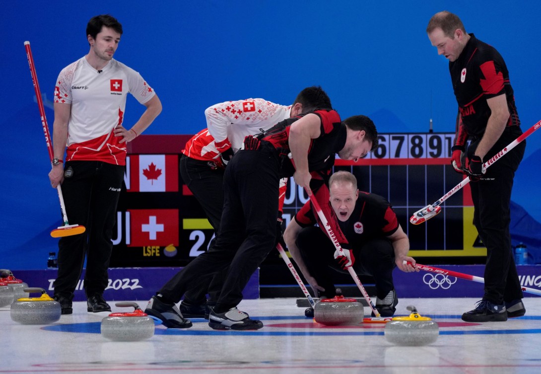 Mark Nichols yells as Brett Gallant sweeps a stone into the house