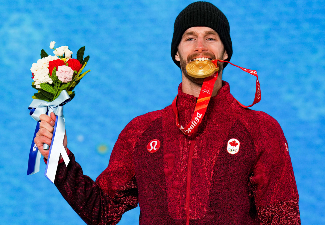 Max Parrot bites his gold medal on the podium