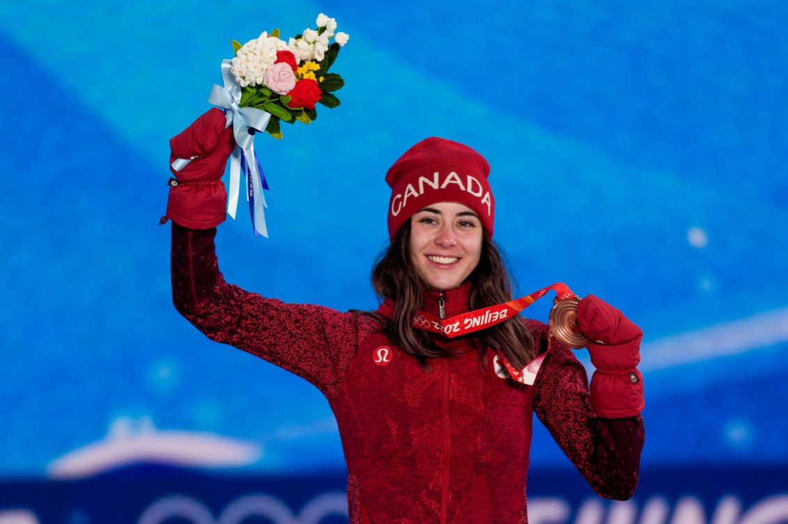 Rachael Karker holds up her flowers on the podium