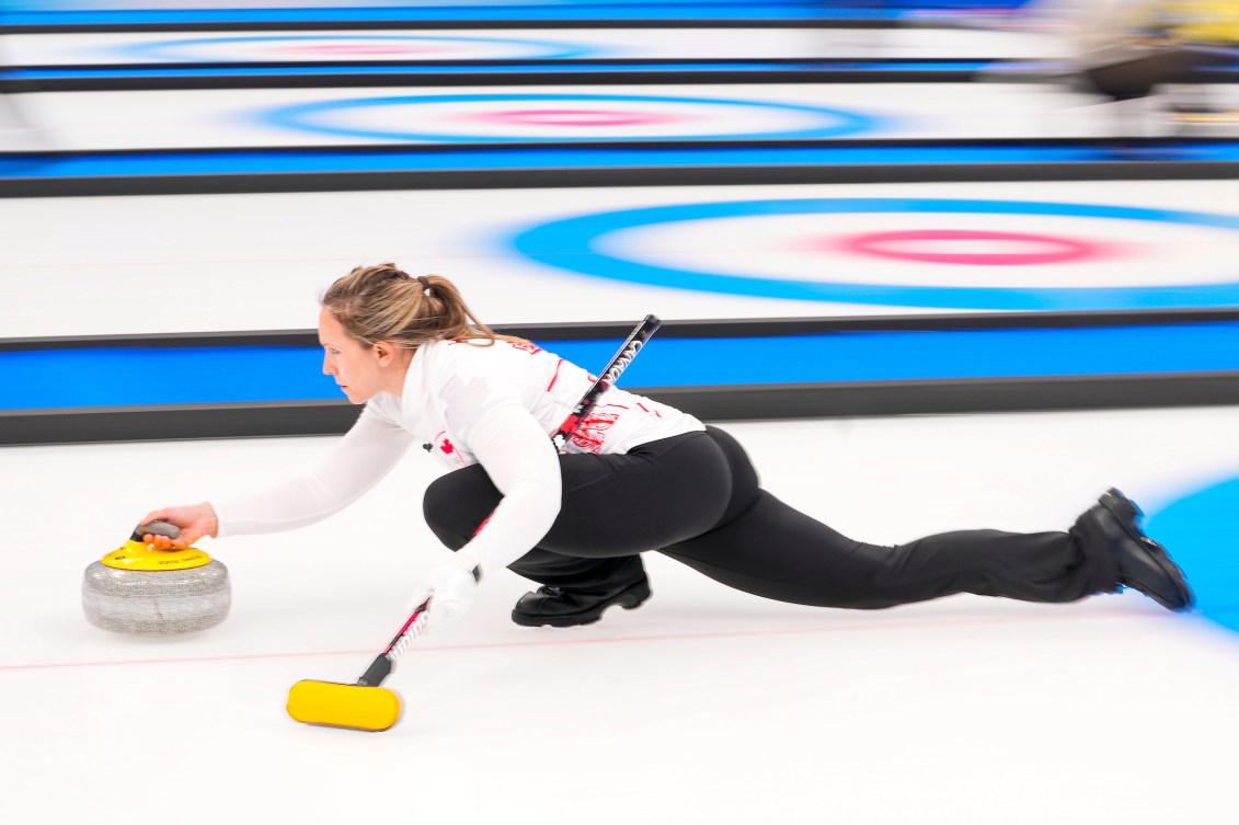 Rachel Homan throws a stone from the hack 