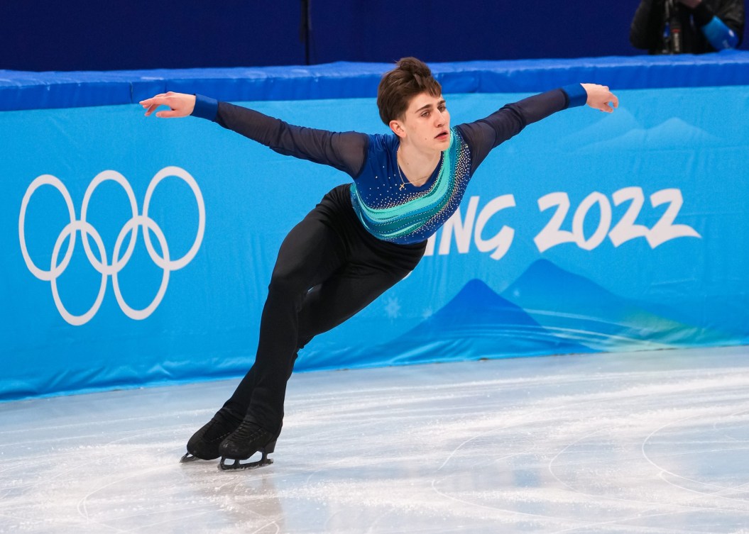 Roman Sadovsky skates with his arms out 