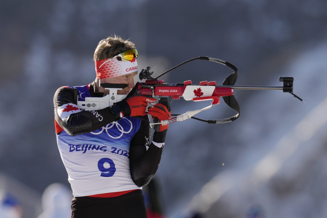 Scott Gow shoots his rifle in biathlon