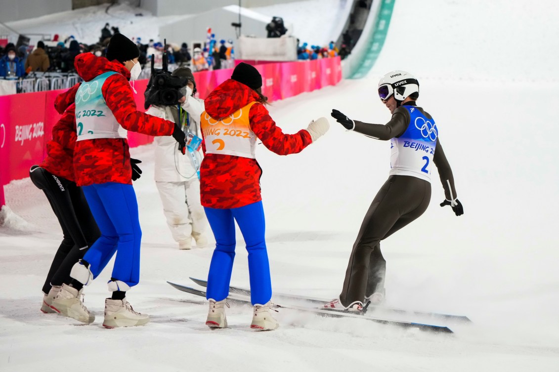 Mackenzie Boyd-Clowes is greeted in finish area by his teammates