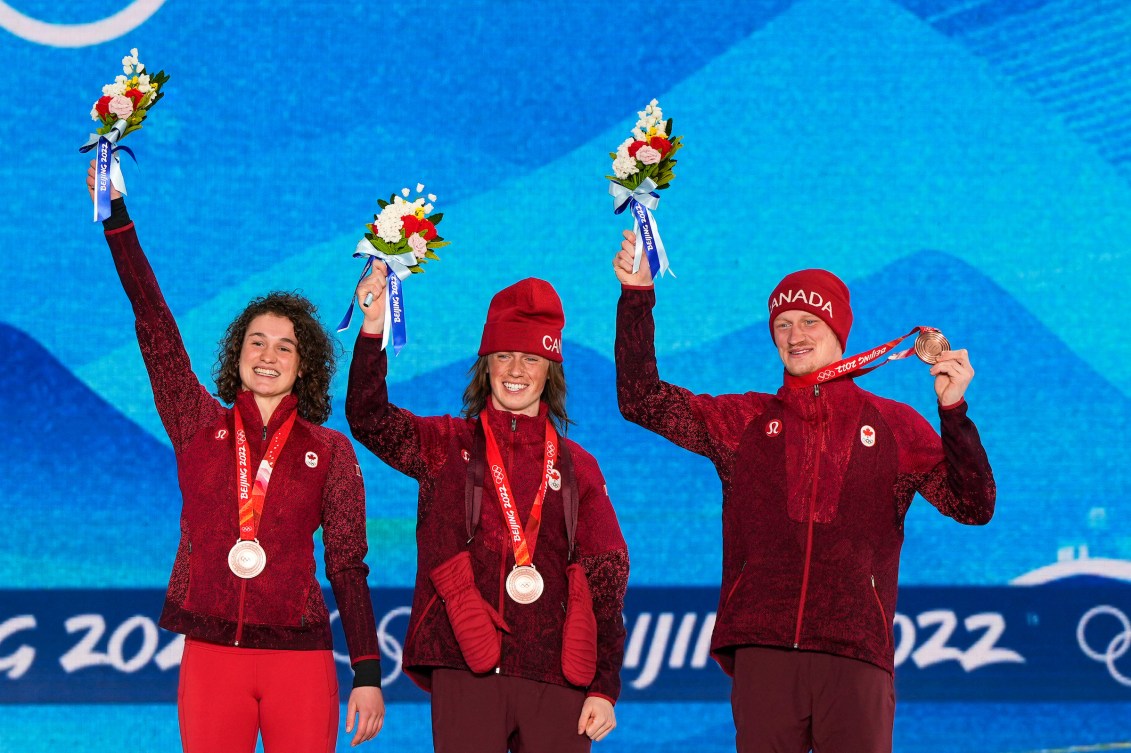 Marion Thernault, Miha Fontaine and Lewis Irving wear their bronze medals on the podium