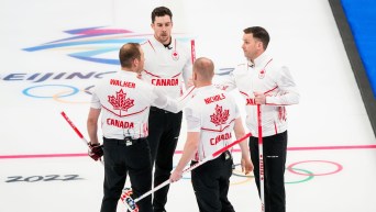 Team Gushue high fives after a win