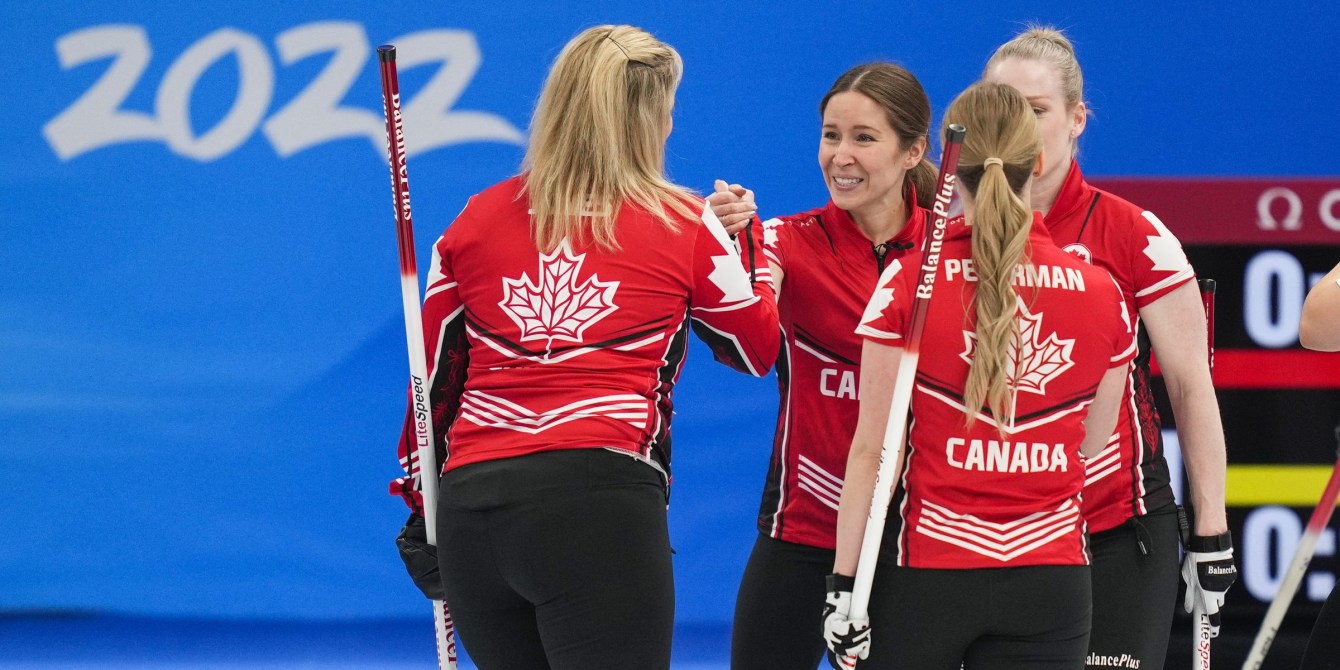 Members of Team Jennifer Jones shake hands after a win