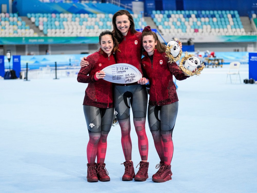 Ivanie Blondin, Isabelle Weidemann and Valerie Maltais pose with their Olympic record plaque