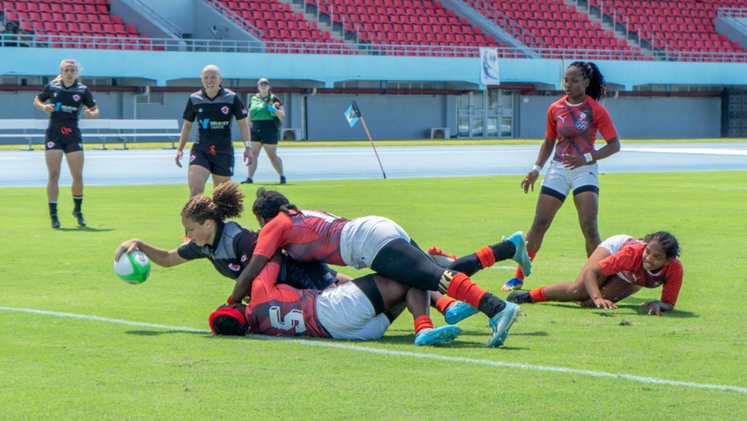 Members from Team Canada's women's rugby team celebrate during a match