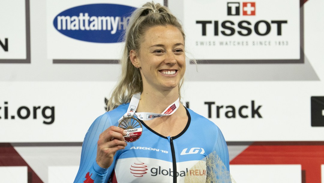 Kelsey Mitchell holds her silver medal on the podium