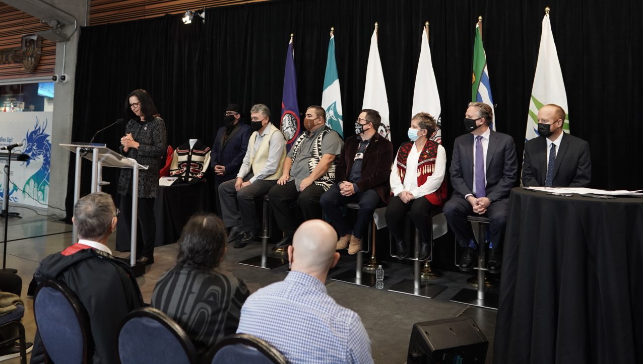 COC President Tricia Smith speaks as members of Chiefs of the Lilwat, Musqueam, Squamish and Tsleil-Waututh First Nations, as well as the Mayors of Vancouver and Whistler look on 