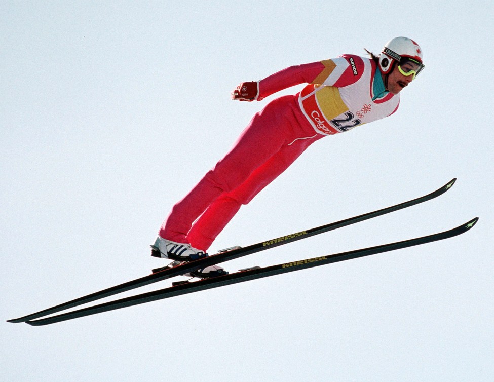 Steve Collins flies through the air while competing in ski jumping