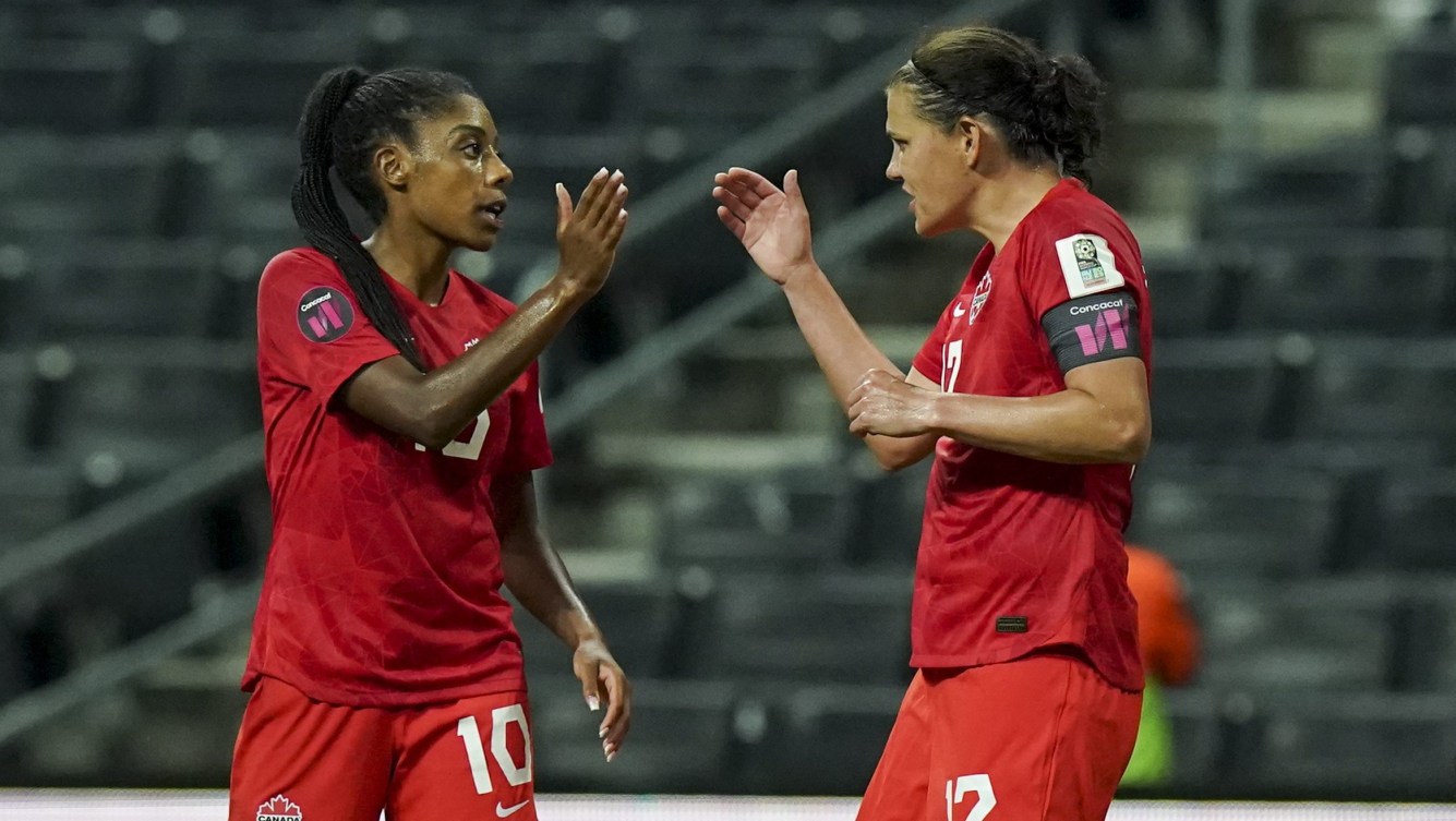 Christine Sinclair and Ashley Lawrence celebrate with a high five