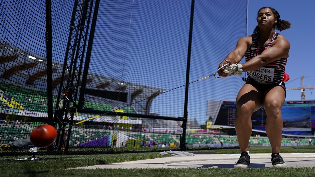 Low angle of Camryn Rogers swinging her hammer in the throwing circle