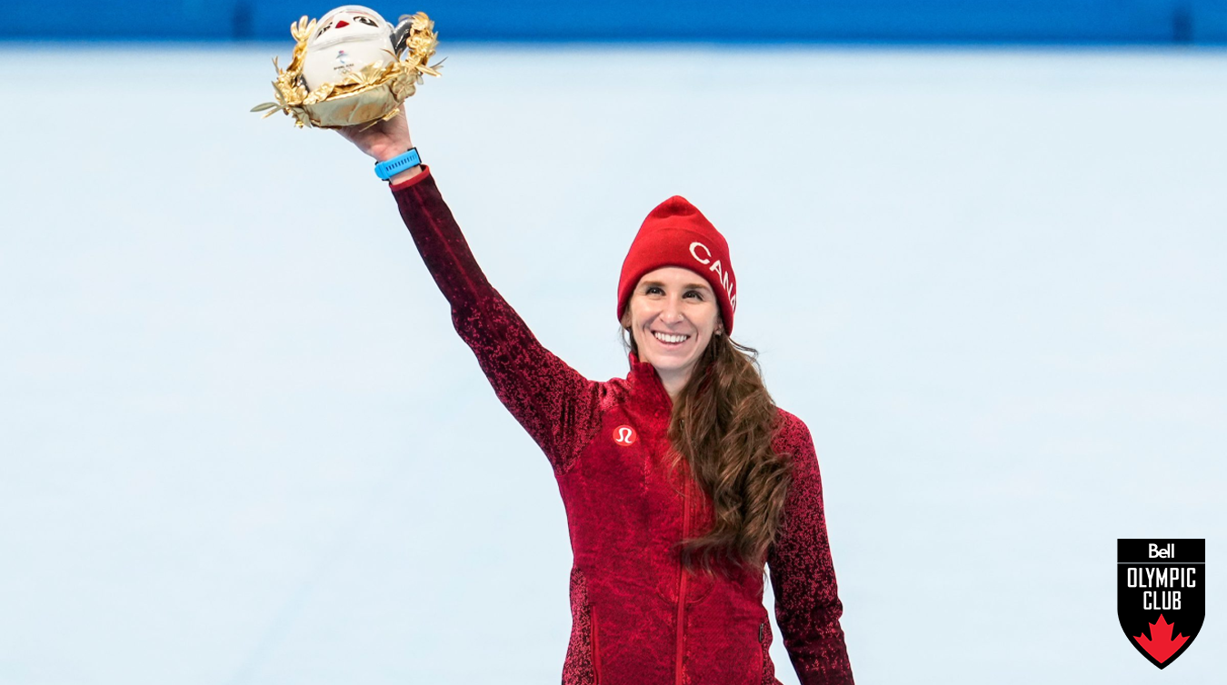 Ivanie Blondin holds her prize in the air