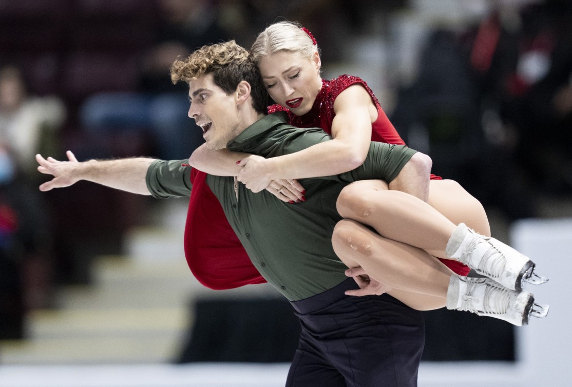 Piper Gilles is carried on the back of Paul Poirier in a lift