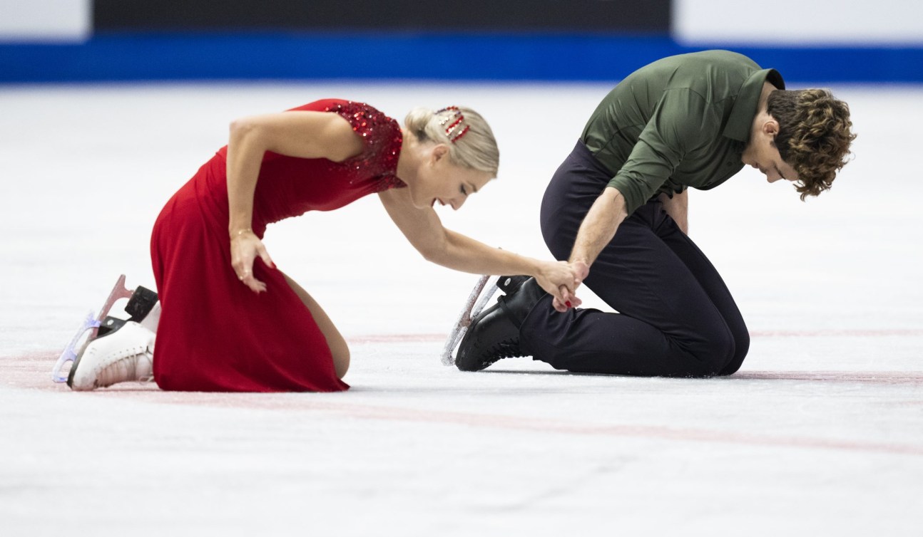 Piper Gilles and Paul Poirier kneel on the ice 