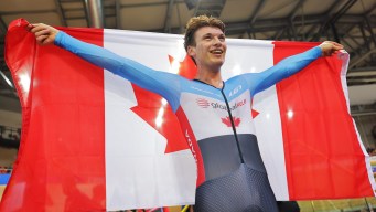 Dylan Bibic hold a Canadian flag.