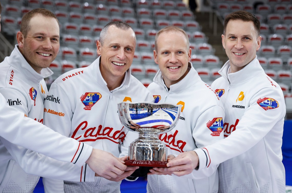 Canada, left to right, lead Geoff Walker, second EJ Harnden, vice-skip Mark Nichols and skip Brad Gushue celebrate winning the men's gold medal game against Korea at the Pan Continental Curling Championships in Calgary, Alta., Sunday, Nov. 6, 2022.  THE CANADIAN PRESS/Jeff McIntosh