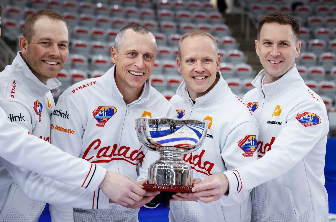 Canada, left to right, lead Geoff Walker, second EJ Harnden, vice-skip Mark Nichols and skip Brad Gushue celebrate winning the men's gold medal game against Korea at the Pan Continental Curling Championships in Calgary, Alta., Sunday, Nov. 6, 2022. THE CANADIAN PRESS/Jeff McIntosh