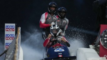Canada's Taylor Austin, of Lethbridge, Alta., Shaquille Murray-Lawrence, of Toronto, Cyrus Gray, of Duncan, B.C., and Davidson De Souza, of Calgary, Alta., celebrate after racing to a third-place finish during the four-man bobsleigh competition at the IBSF bobsleigh world cup event, in Whistler, B.C., on Saturday, November 26, 2022. THE CANADIAN PRESS/Darryl Dyck
