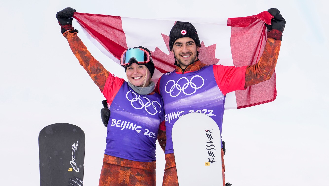 Team Canada snowboarders Eliot Grondin and Meryeta Odine celebrate after winning bronze in the mixed teams snowboard cross event during the Beijing 2022 Olympic Winter Games