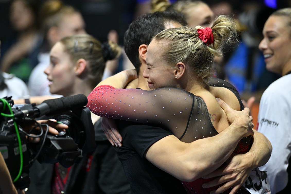 Ellie Black cries as she hugs her coach 