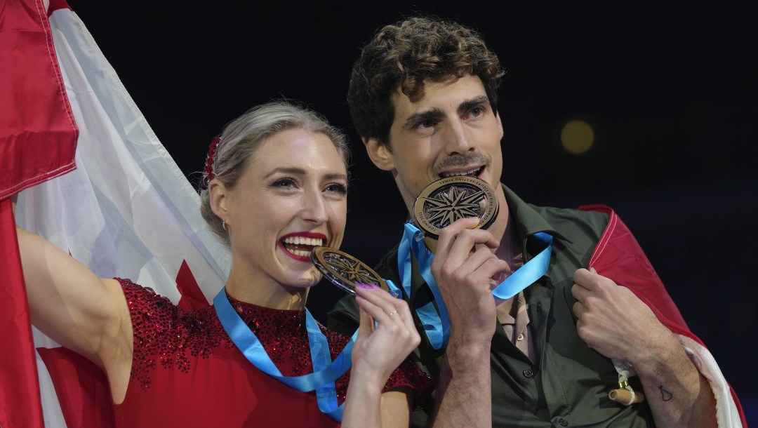 First place, Canada's Piper Gilles and Paul Poirier, pose during a victory ceremony after the Ice Dance Free Dance at the figure skating Grand Prix finals at the Palavela ice arena, in Turin, Italy, Saturday, Dec. 10, 2022. (AP Photo/Antonio Calanni)