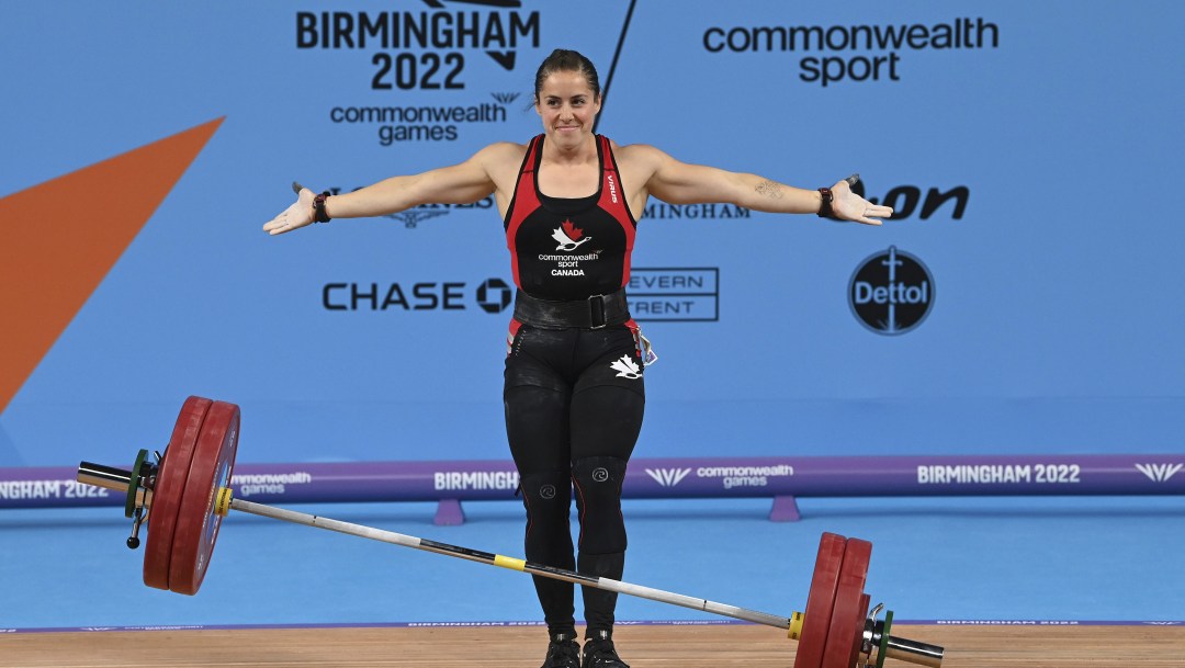 Maude Charron half smiles after dropping the barbell in weightlifting competition