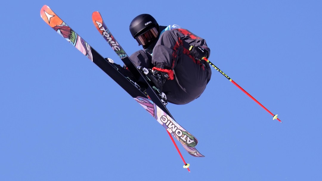 Megan Oldham grabs her ski while performing a trick