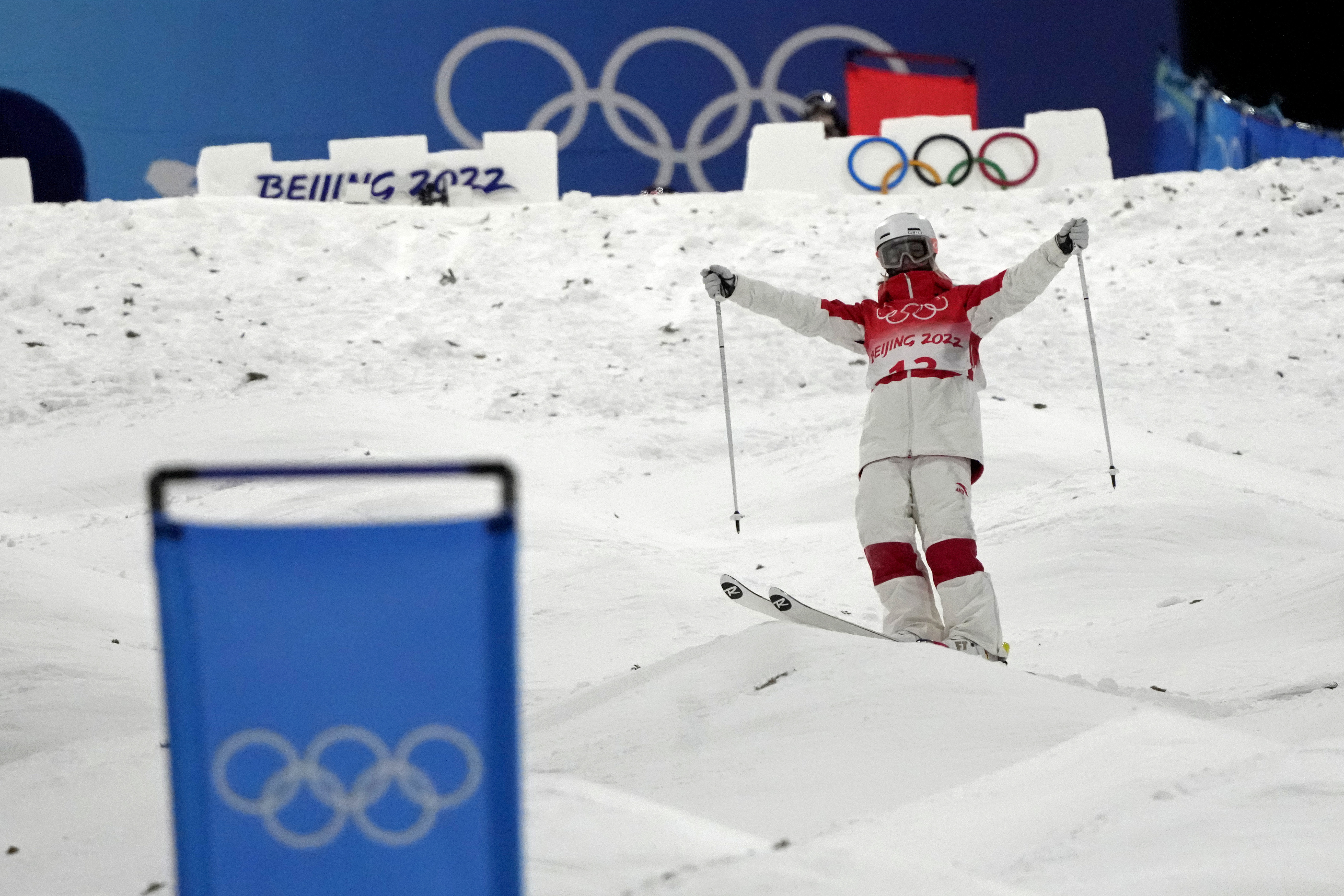 Justine Dufour-Lapointe holds out her arms after standing up from a crash