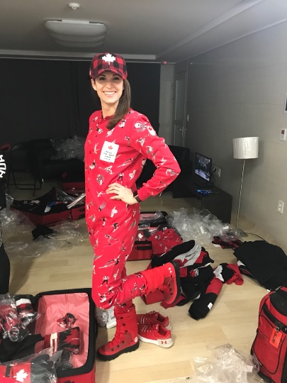 Lisa Weagle poses in a red onesie in a messy living room