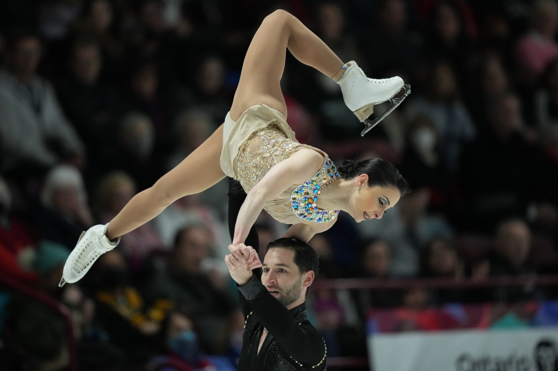Deanna Stellato-Dudek in a lift over the head of partner Maxime Deschamps