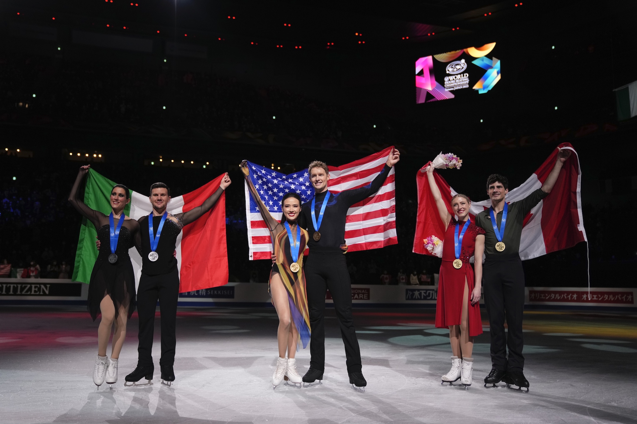 Madison Chock and Evan Bates of the U.S., center, with gold medals, Charlene Guignard and Marco Fabbri of Italy, left, with silver medals, and Piper Gilles and Paul Poirier of Canada, with bronze medals, pose for a photo at the end of the award ceremony for the ice dance free dance in the World Figure Skating Championships in Saitama, north of Tokyo, Saturday, March 25, 2023.