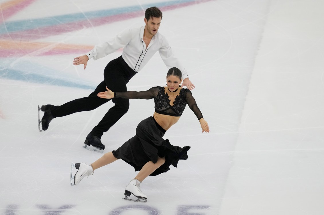 Laurence Fournier Beaudry and Nikolaj Soerensen dance side by side on ice 