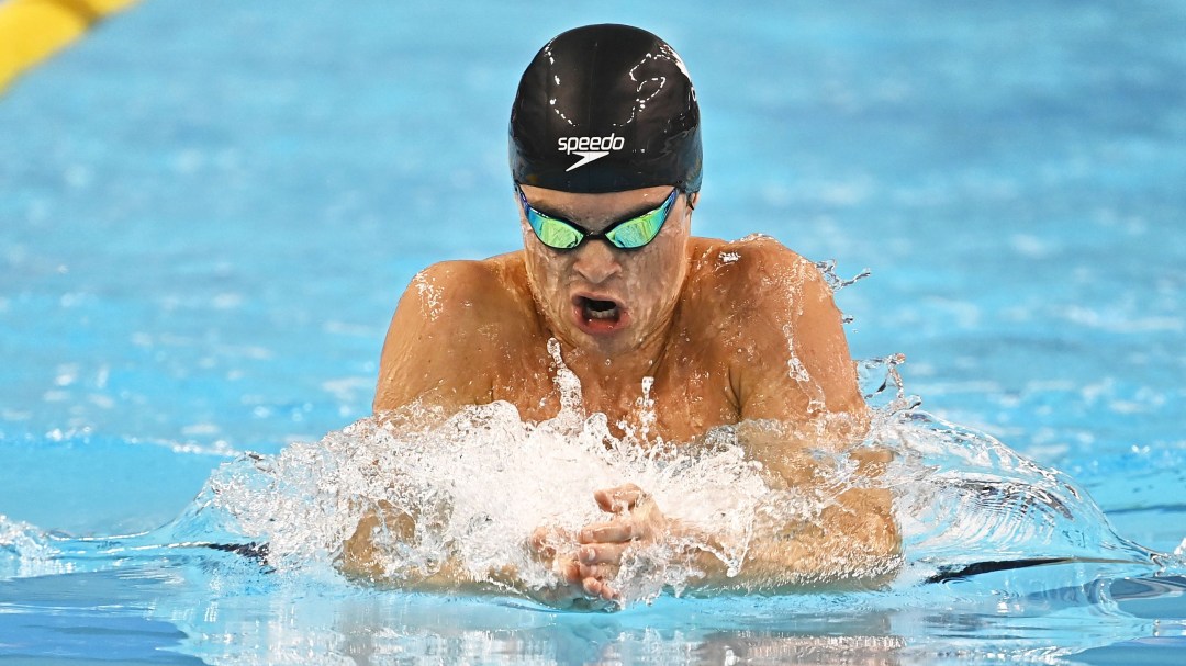 Brayden Taivassalo swims breastroke in a black cap