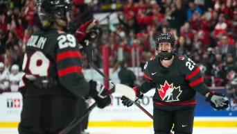 Marie-Philip Poulin and Erin Ambrose celebrate a Team Canada goal at 2023 IIHF Women's World Championship.