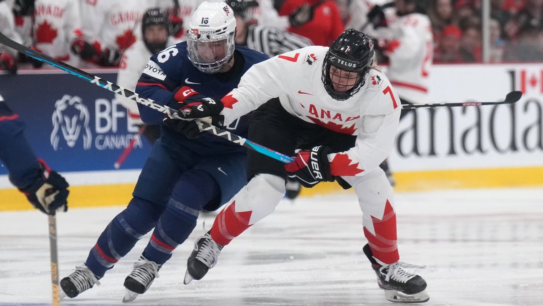 Team Canada's Laura Stacey battles for the puck against the United States at the 2023 IIHF Women's World Championship.