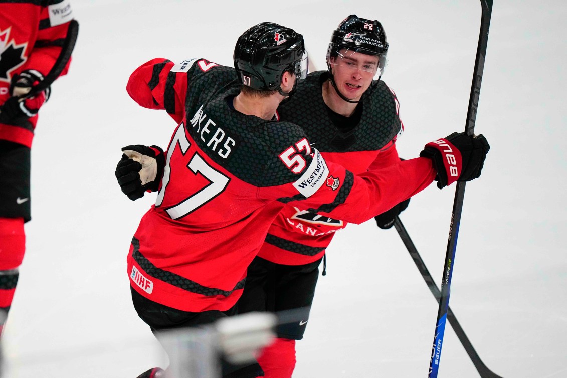 Jack Quinn and Tyler Myers celebrate a goal against Latvia at the IIHF World Championship.