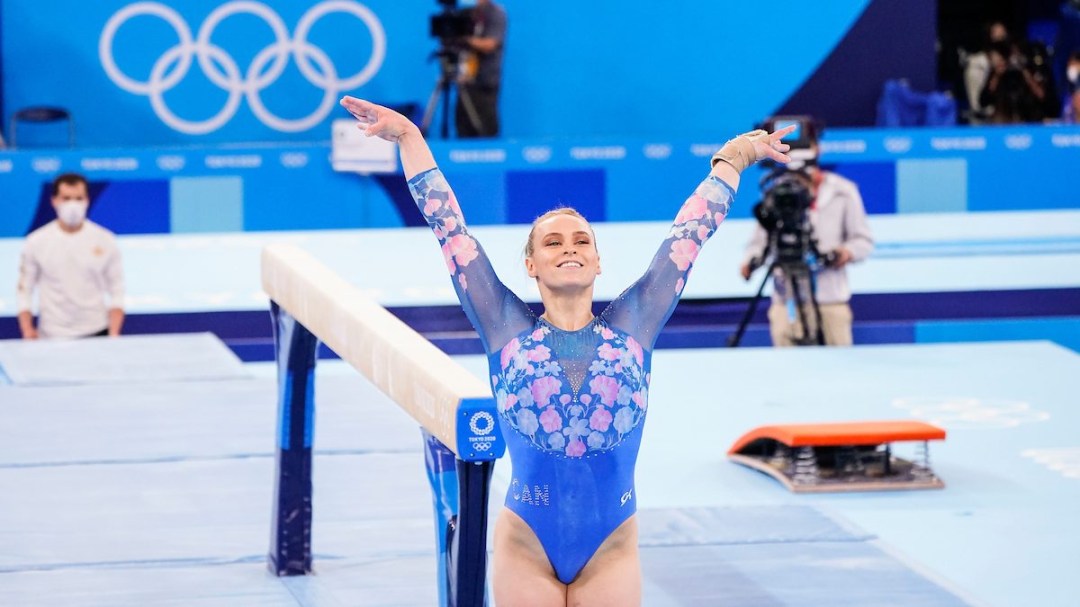 Ellie Black holds her arms out to present herself at the end of a beam routine