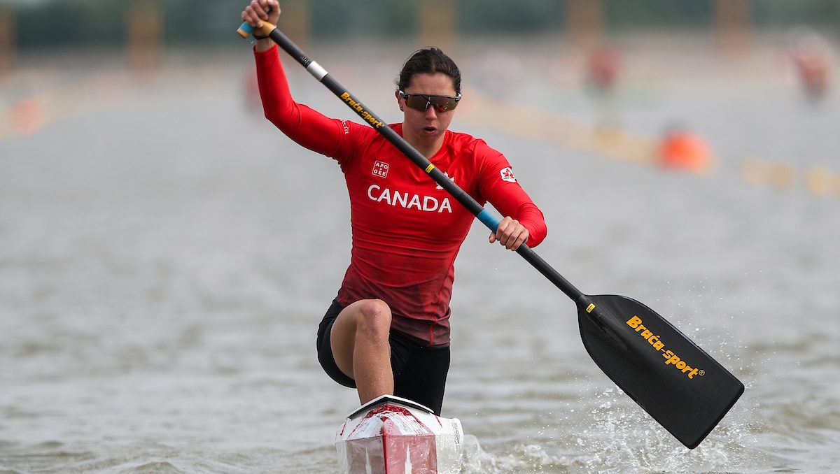 Katie Vincent paddles a canoe in a sprint race